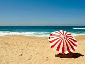 Red umbrella on the beach in summer